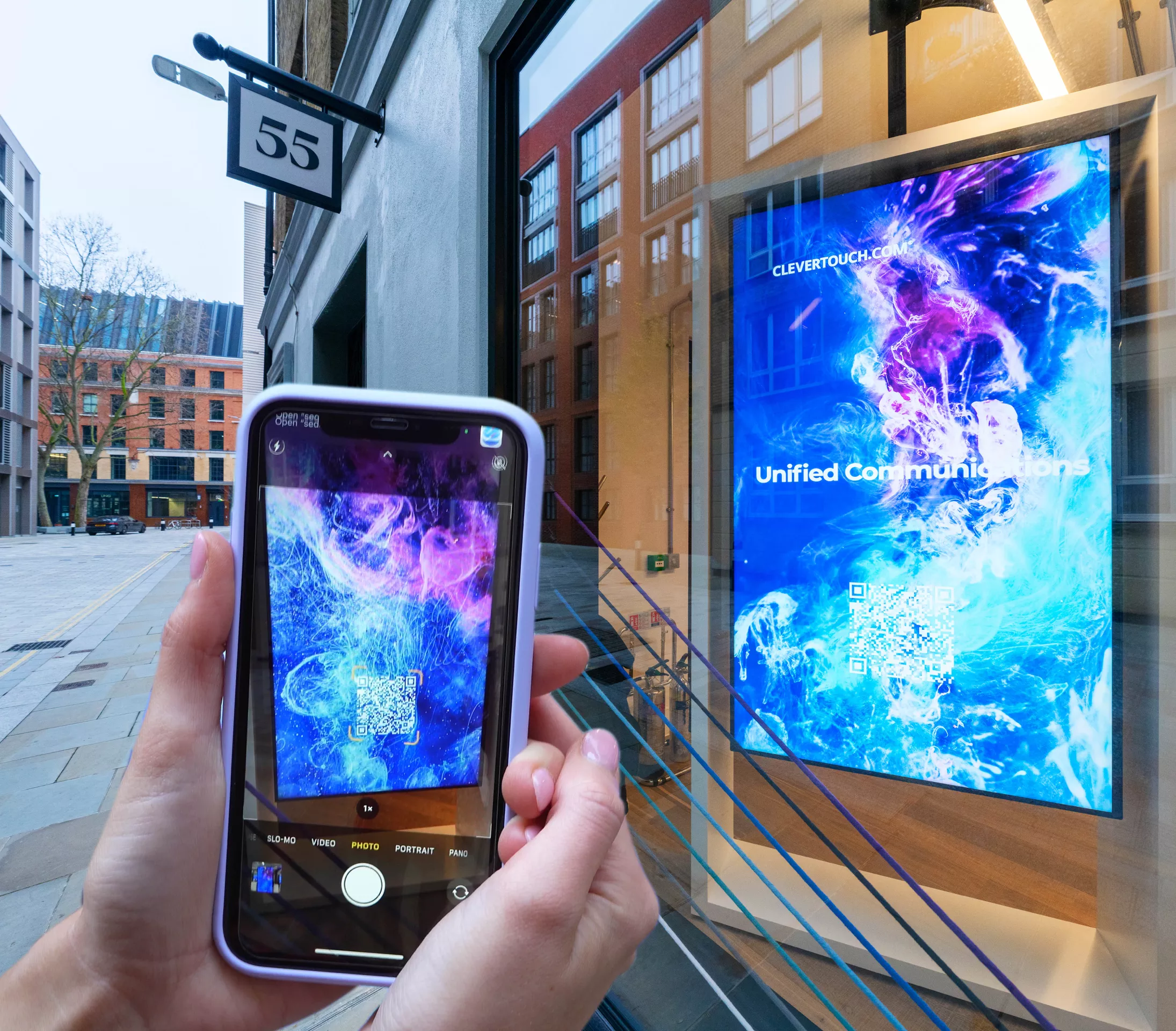 Clevertouch digital signage while someone is scanning the QR code featured with their phone