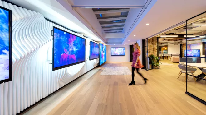 A person walking towards the screens at the Clevertouch Showroom
