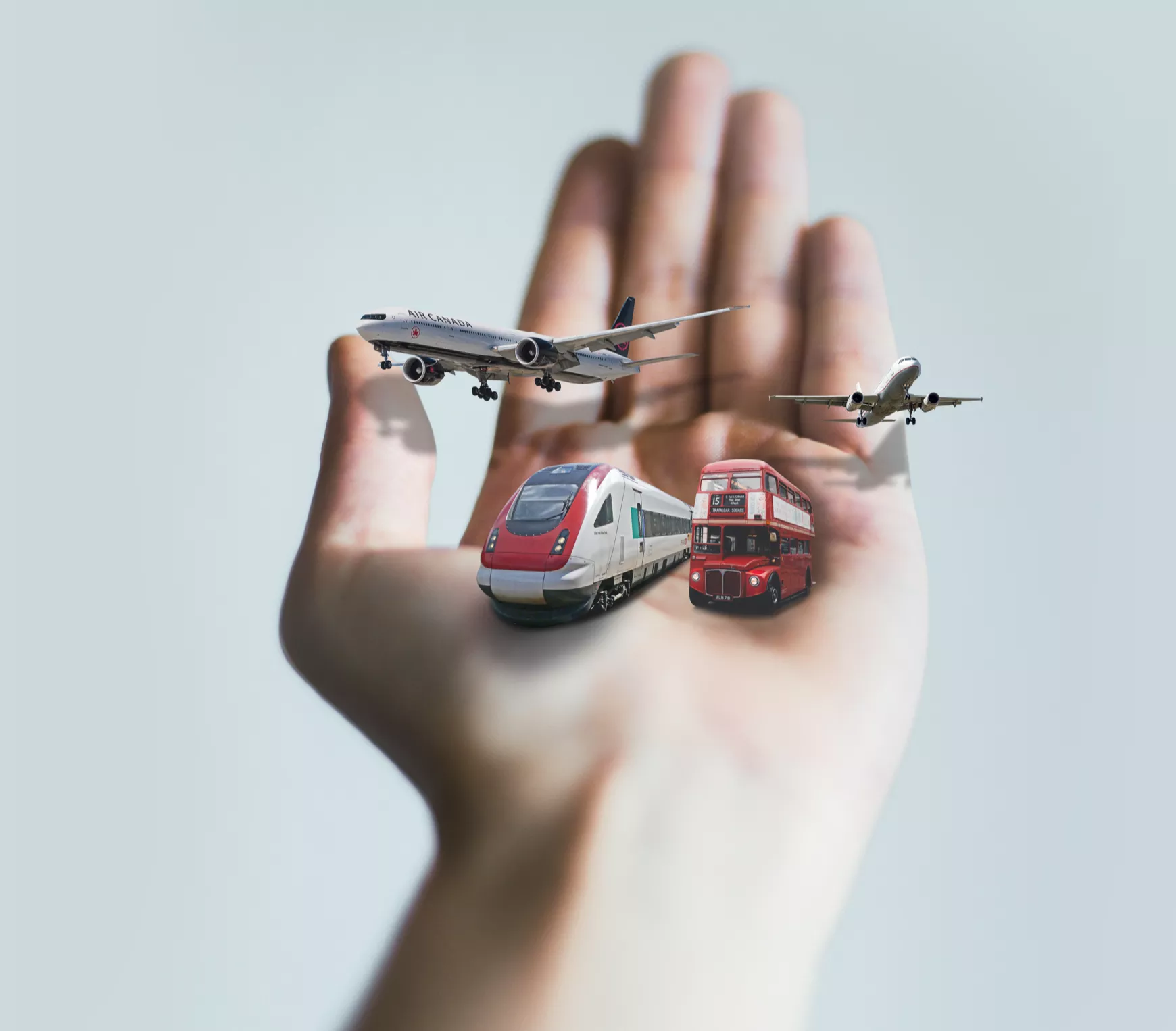 Two planes, a bus and a train in the palm of a hand