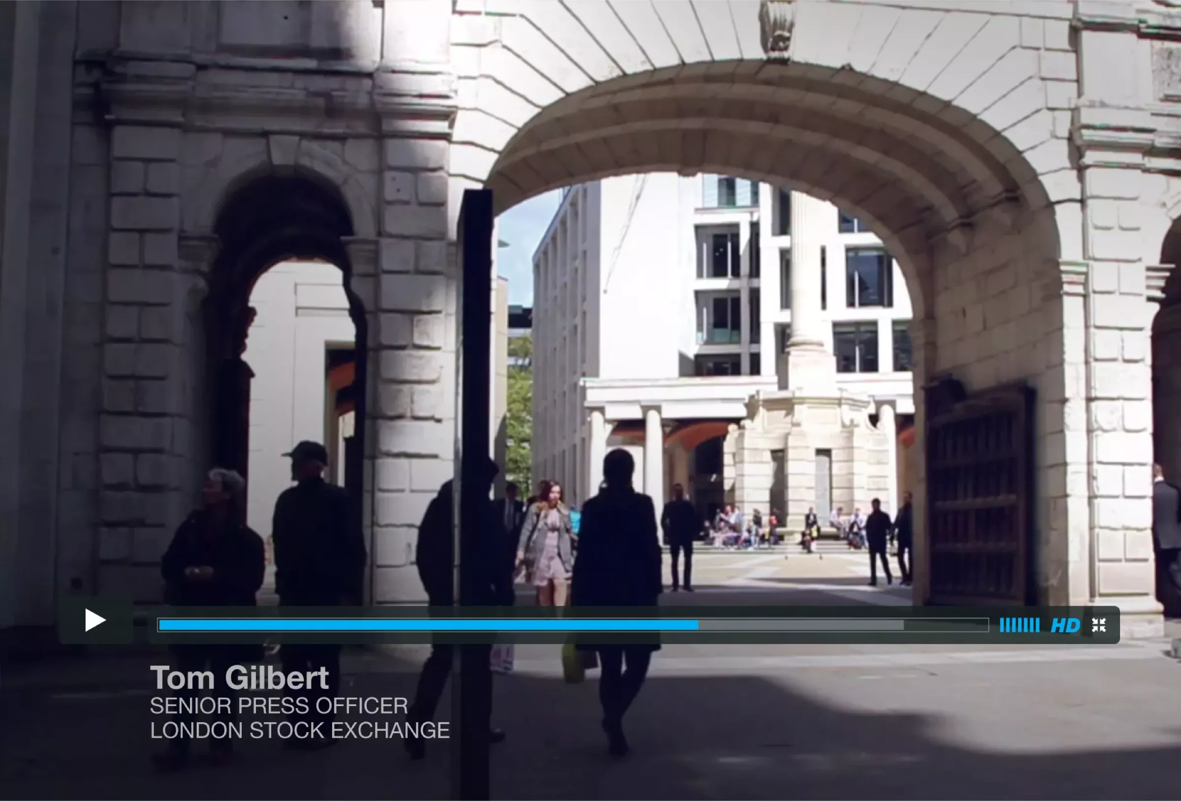 An archway in London with people walking around