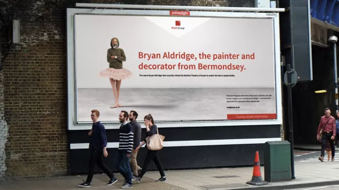 A billboard featuring REaD group branding and a man in a tutu