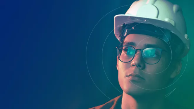 Person in a hard hat with the Chloride logo overlayed and the Chloride green/blue background