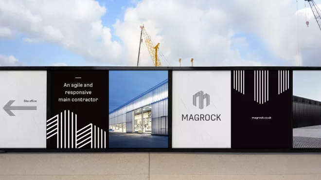 Construction site safety fence with black and white Magrock branding