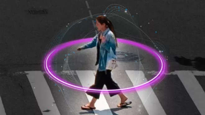 A person walking across a zebra crossing with a purple ring encircling them